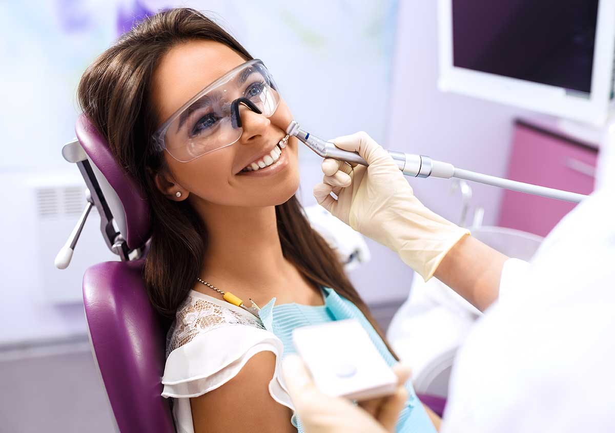 Dental professional treating tooth damage with a conservative, tooth-colored filling